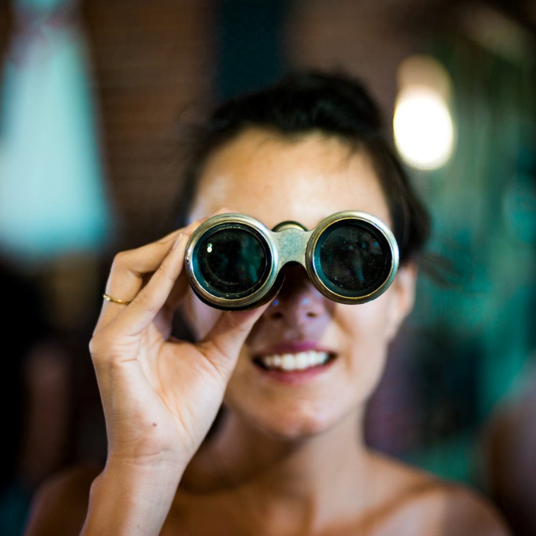 woman looking through binoculars