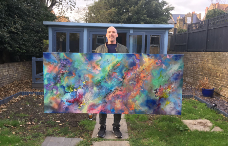 Shane McCoubrey holding his painting